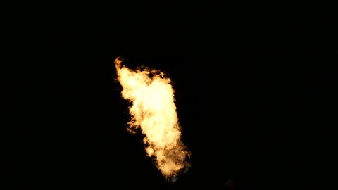 Slowmotion of blazing fire flames over black background