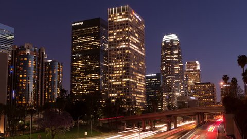 LOS ANGELES, CA, USA - APR17, 2015: 4K Time lapse zoom in rush hour traffic downtown Los Angeles skyline at sunset and twilight