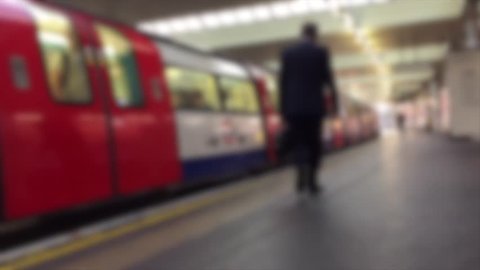 London underground tube train arrives station platform blurred abstract background