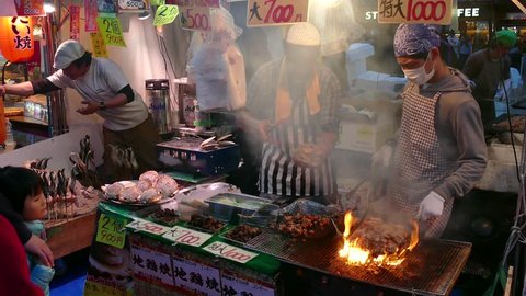 TOKYO, JAPAN - NOVEMBER 2016 - Ueno Park, Tokyo, Japan, Asia. Japanese people, tourists and small business, family-run stall selling traditional Asian street food at fair