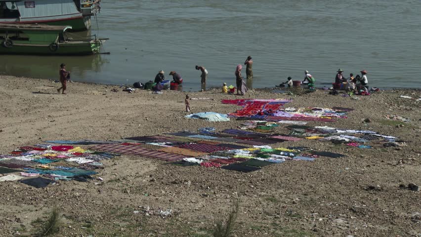 People washing clothes in te river, Mandalay, Myanmar
