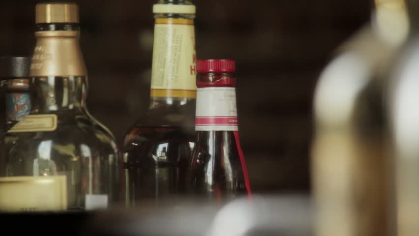 VIRGINIA - SUMMER 2016 - Reenactment, Recreation, historical Tavern, saloon, bar with freshly poured beer in glasses, beer taps and amber bottles of alcohol on shelves and bar top. shots of whiskey.