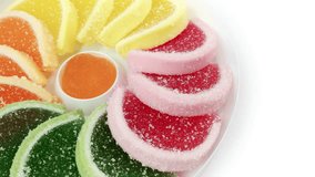 Jellies rotating sugary fruit on white background