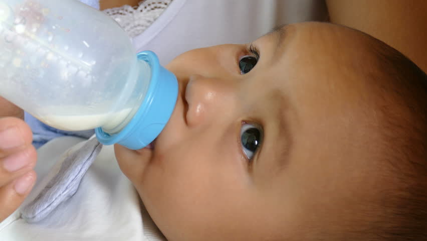 Asian mother feeds her baby with bottle | Shutterstock HD Video #23689303