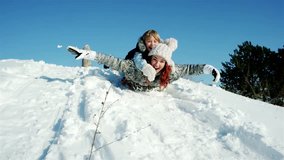 family sleigh ride through snow, happy mother and son moves down on sled, sledding down hills, fast descent on snowy slope in woods, fun winter holidays, fun winter - Powered by Shutterstock - Get 15% off with code: PIKWIZARD15
