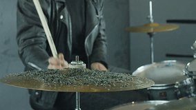 Drummer hitting on drum cymbal, and the sand splashing from cymbal in slow motion 200 fps.  Shot on RED HELIUM Cinema Camera.