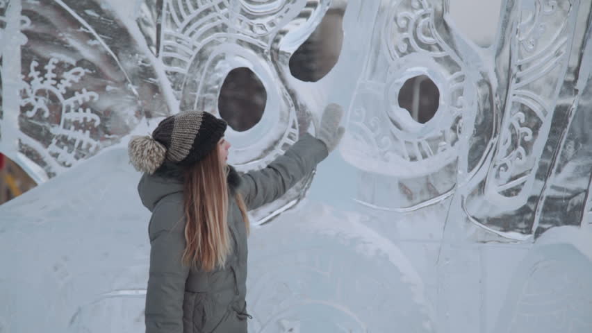 young woman smiling at the ice sculptures, winter gloves Royalty-Free Stock Footage #23695792