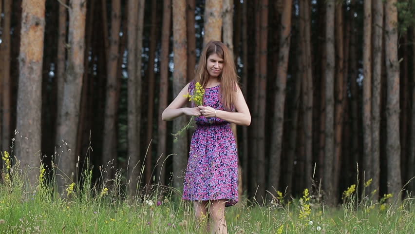 girl picking flowers in the woods, in the Park