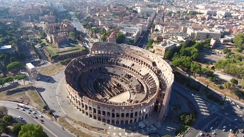 Aerial Colosseum flying slowly to left also known as Coliseum or Flavian Amphitheater or Colosseo oval amphitheatre centre Rome Italy largest amphitheatre ever built popular tourist attraction 4k