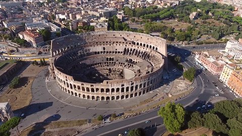 Aerial flying slowly backwards away from Colosseum also known as Coliseum Flavian Amphitheatre Colosseo oval amphitheatre centre Rome Italy largest amphitheatre ever built popular tourist attraction