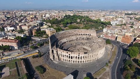 Aerial flying towards Colosseum also known as Coliseum or Flavian Amphitheater or Colosseo oval amphitheatre centre Rome Italy largest amphitheatre ever built popular tourist attraction in Italy 4k