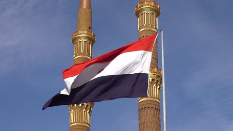 Egyptian Flag Fluttering in the Wind, Against the Background of the Two Towers of the Mosque Flag