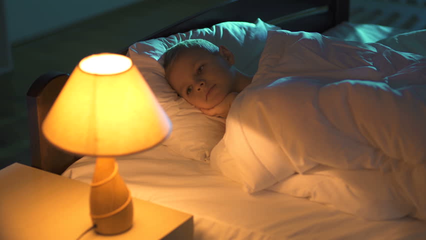 The sleeping boy turn off the lamp. Evening night time. Real time capture
 Royalty-Free Stock Footage #23718418