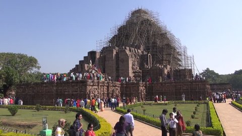 KONARK, INDIA - DECEMBER 28, 2013.  Many peoples in medieval UNESCO heritage, ruined temple of Sun god, Odisha, India