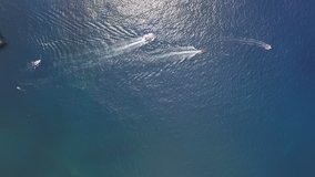 Three boats floating on open sea. Filmed with drone in slow motion.