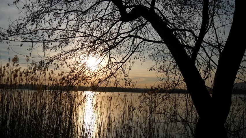 a scenic view of the lake Annone, also called lake Oggiono, at sunset.  It is a pond close to lake Como, Lombardy, Italy.    A thin layer of ice covering the surface.