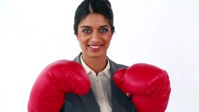 Smiling executive using red boxing gloves against a white background - Powered by Shutterstock - Get 15% off with code: PIKWIZARD15