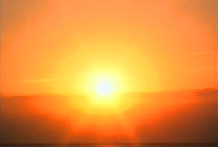 Sun setting into clouds