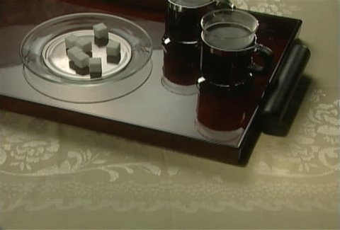 Serving tray with coffee cups and sugar cubes