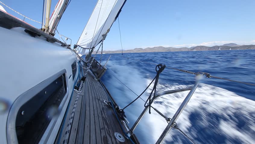 Sailing in the wind through the waves. Sailing boat shot in full HD at the