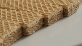 Panning on  Israeli type wafer pieces on plate 4K 21560p 30fps UltraHD footage - Close-up sweet thin waffle biscuit pattern slow pan 