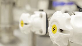 Pharmaceutical Worker Turning Handles on Equipment in Clean Room Environment - Close Up - Powered by Shutterstock - Get 15% off with code: PIKWIZARD15