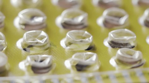 Soft focus tracking over an empty package of birth control pills. The oral contraceptives are taken daily to prevent unwanted pregnancy.