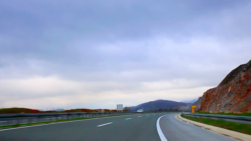 Car driving on highway before rain time lapse