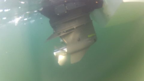 Underwater shot of the propeller of an outboard engine
