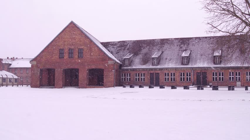 Steadicam shot of concentration camp brick building in winter. 4K video