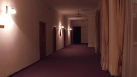 POV steadicam walk through generic hotel corridor. Automatic turning on of the light. 4K clip