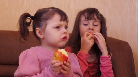 Little girl eating an apple. 