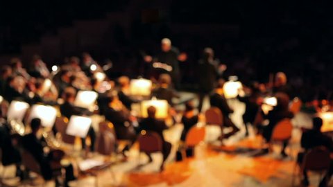 Orchestra performs a concert (out of focus)