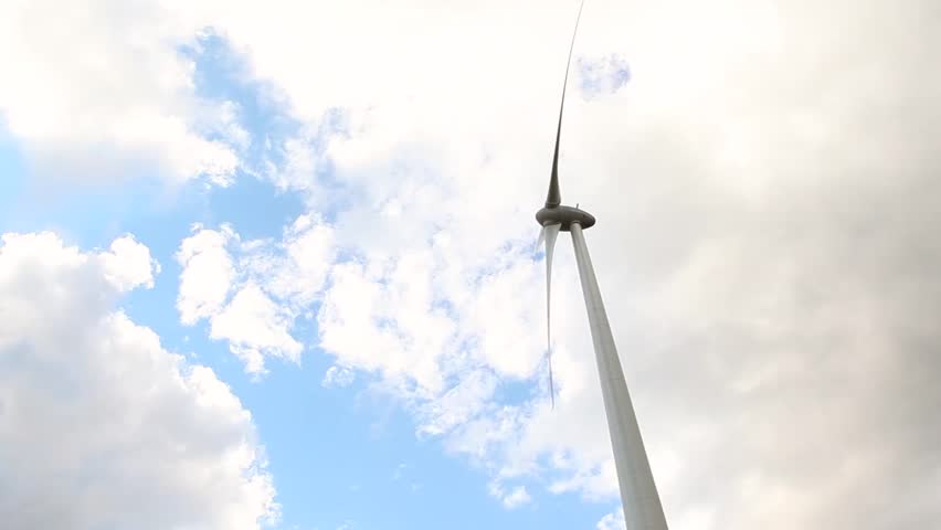 Time-lapse of windmill spinning on a cloudy day