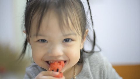 Closeup portrait Asian girl eating watermelon 