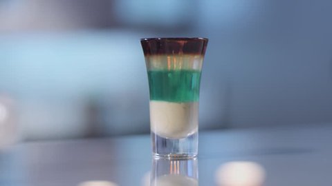 Layered cocktail in a shot glass