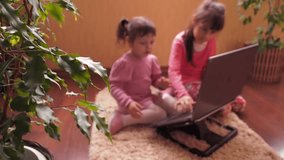 Little sisters with laptop