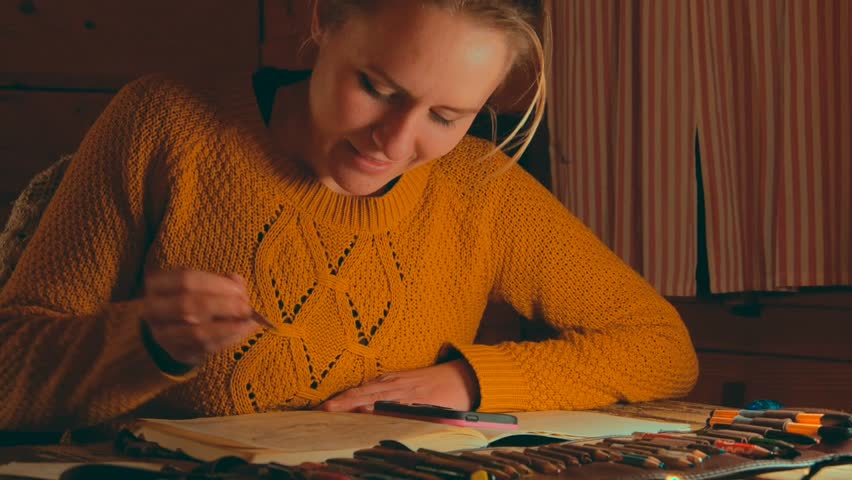 female artist drawing artwork at home at night, cozy cottage atmosphere, matching stills also available in portfolio 