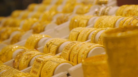 Gold bracelets on the market in Dubai. Eastern Market with gold ornaments. Golden Arab market in the UAE. gold market. Showcase with gold bracelets. Jewelry store: shelves.