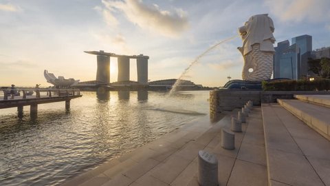 Beautiful and clear day to night time lapse of Singapore cityscape at Marina bay quay, Singapore. 4K UHD, Motion Timelapse Slow Slide from Right to Left