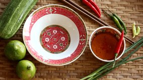 Preparing Spring roll on a plate by using chopsticks to hold with vegetables on bamboo basket background, Vintage style, Vietnamese food, food concept footage