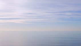 Beautiful calm sea water and blue sky. Small boat passing by, nature background