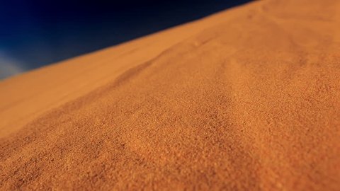 closeup camera moves along yellow quicksand in white sand dunes