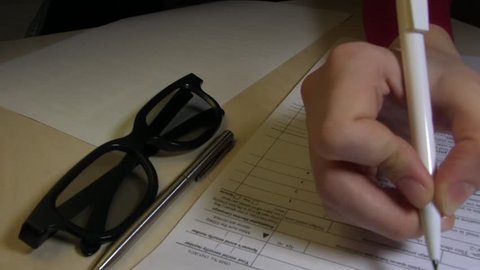 A Woman Is Completing The US Individual Income Tax Return Form 1040, Year 2016
