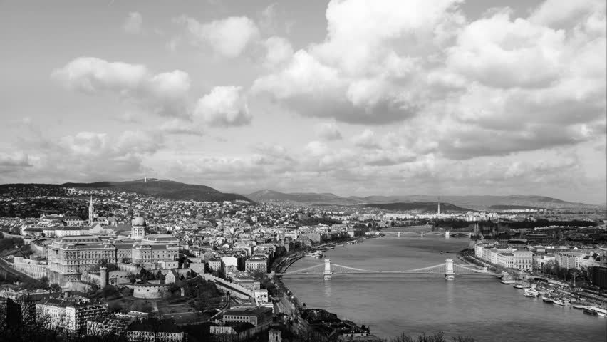 Aerial view of Budapest, Hungary with clouds running at a fast pace. Buda castle, Chain bridge and Parliament building. Time-lapse in black and white