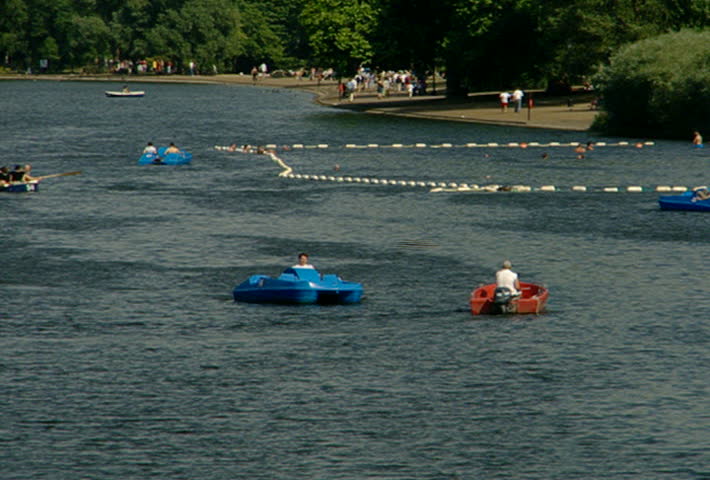 Paddle and motor boats move across the Serpentine lake in Hyde Park, London in 2002.