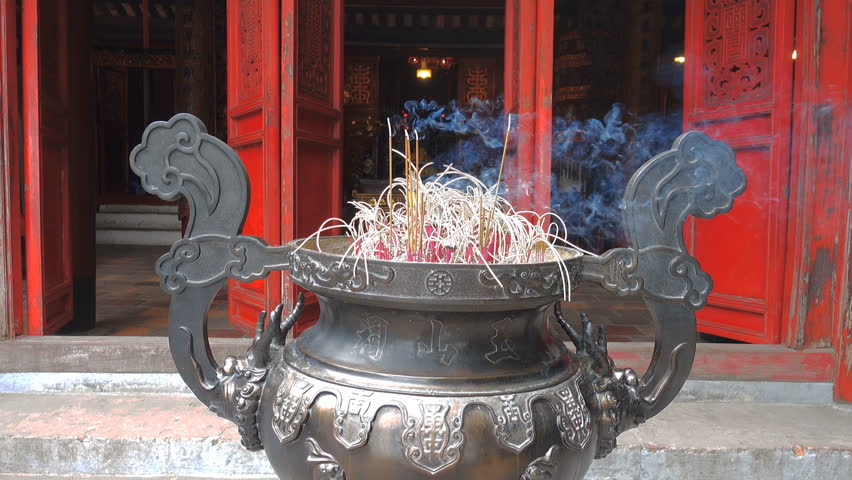 Slow motion of burning Incense in brazier at the Ngoc Son Temple (Temple of the Jade Mountain) in Hanoi, Vietnam. Celebrate Chinese New Year ritual for prosperity and happiness. 