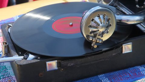 The record player plays old classical music, the portable player of vinyl records.