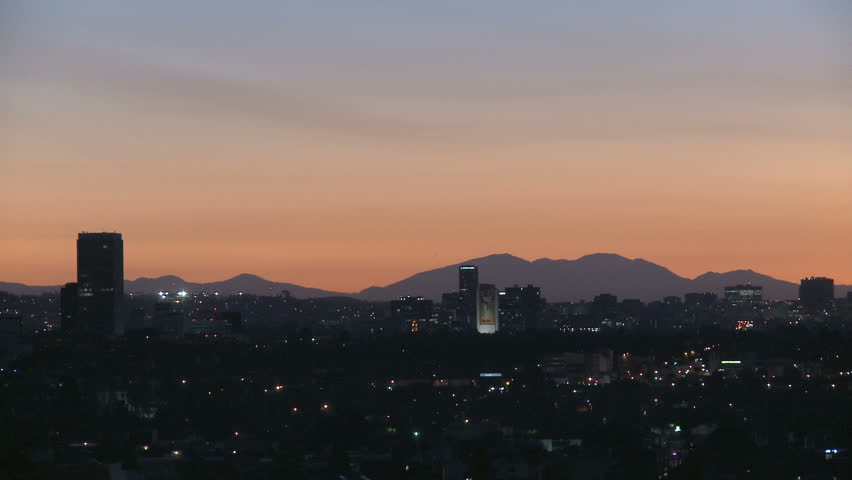 Downtown Los Angeles skyline at sunrise with heat haze and mountains in the