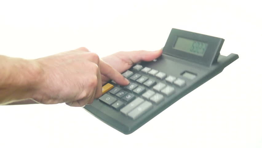 Calculating on calculator on white background.